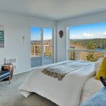 Master Suite opens to view deck. Double closets PLUS Walk-in closet, all with organizers. Spa Bath with soaking tub overlooks panoramas of lake, sky, mountains and forest.